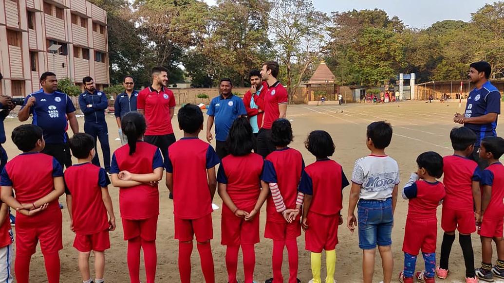 Mario Arques and Sergio Cidoncha enjoy a game of football with the students of DBMS Football School.