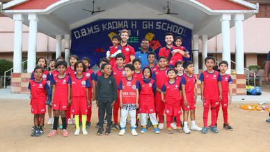 Mario Arques and Sergio Cidoncha enjoy a game of football with the students of DBMS Football School.
