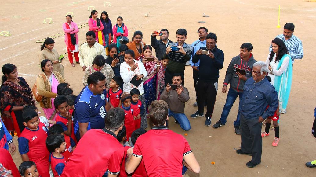 Mario Arques and Sergio Cidoncha enjoy a game of football with the students of DBMS Football School.