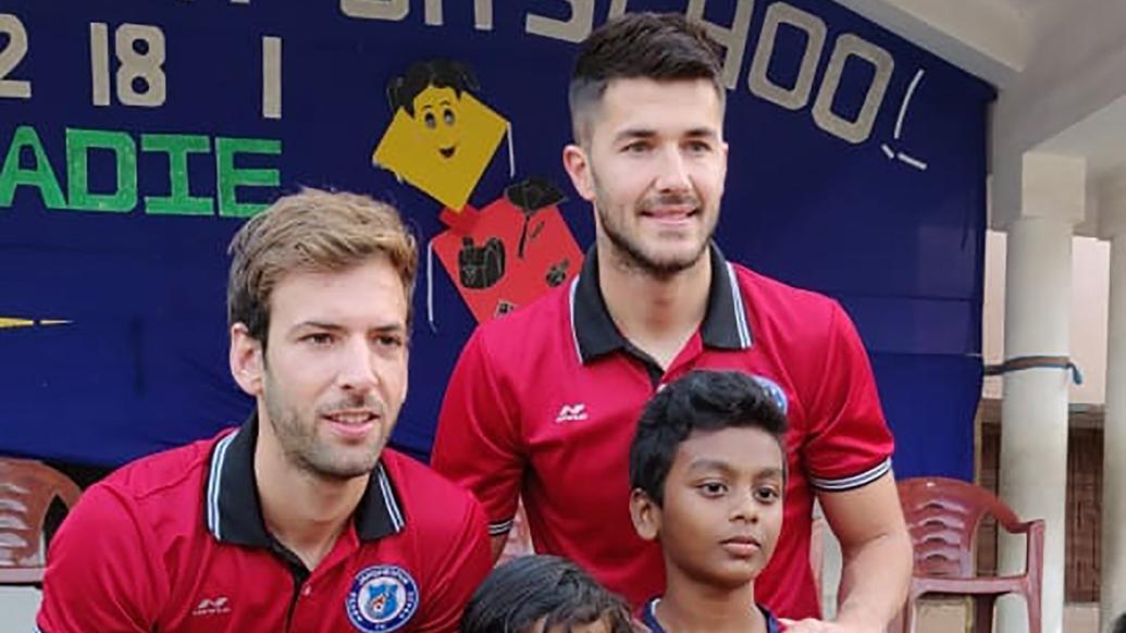 Mario Arques and Sergio Cidoncha enjoy a game of football with the students of DBMS Football School.
