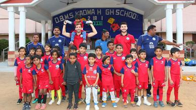 Mario Arques and Sergio Cidoncha enjoy a game of football with the students of DBMS Football School.