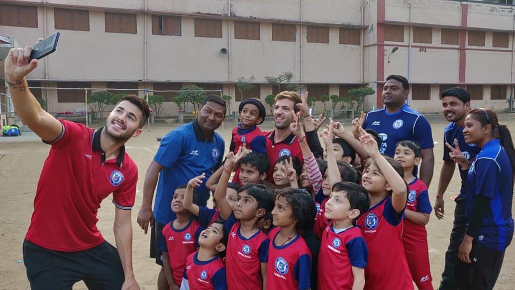 Mario Arques and Sergio Cidoncha enjoy a game of football with the students of DBMS Football School.