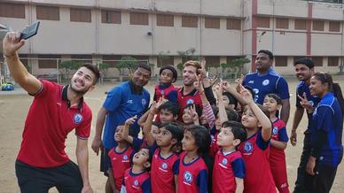 Mario Arques and Sergio Cidoncha enjoy a game of football with the students of DBMS Football School.