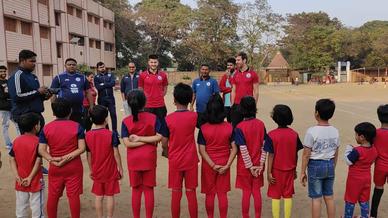 Mario Arques and Sergio Cidoncha enjoy a game of football with the students of DBMS Football School.